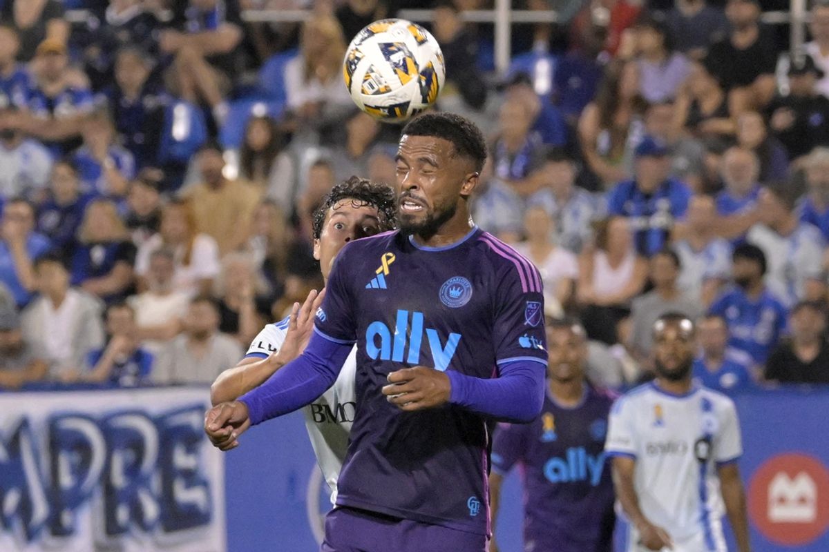 Sep 14, 2024; Montreal, Quebec, CAN; Charlotte FC defender Nathan Byrne (14) heads the ball against CF Montreal midfielder Caden Clark (23) in the first half at Stade Saputo. Mandatory Credit: Eric Bolte-Imagn Images