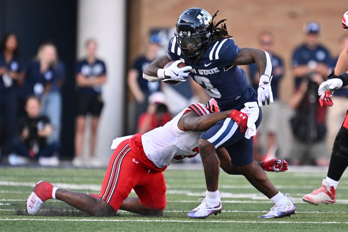 Sep 14, 2024; Logan, Utah, USA;  Utah State Aggies running back Rahsul Faison (3) is brought down by Utah Utes linebacker Levani Damuni (3) after a short gain in the second half at Merlin Olsen Field at Maverik Stadium. Mandatory Credit: Jamie Sabau-Imagn Images