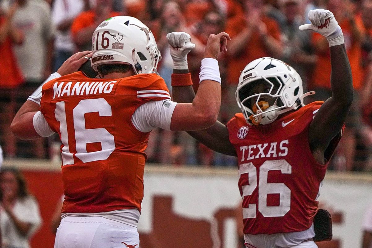Texas Longhorns quarterback Arch Manning (16) and running back Quintrevion Wisner (26) celebrate a touchdown by Manning during the game against UTSA at Darrell K Royal-Texas Memorial Stadium in Austin Saturday, Sept. 14, 2024.