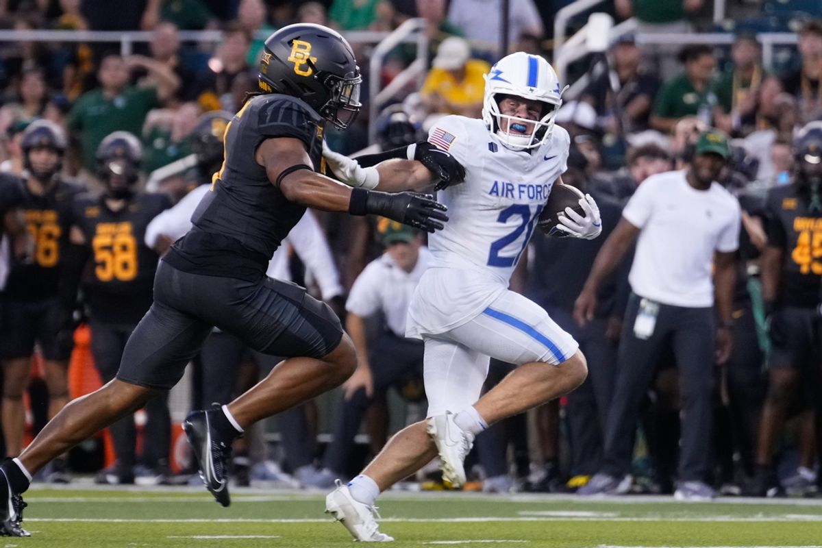 Sep 14, 2024; Waco, Texas, USA; Air Force Falcons wide receiver Cade Harris (21) runs with the ball while being chased by Baylor Bears linebacker Keaton Thomas (11) during the first half at McLane Stadium. Mandatory Credit: Chris Jones-Imagn Images
