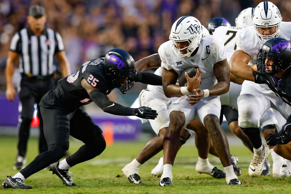 Sep 14, 2024; Fort Worth, Texas, USA; UCF Knights quarterback KJ Jefferson (1) scrambles with TCU Horned Frogs safety Jaise Oliver (25) closing during the second quarter at Amon G. Carter Stadium. Mandatory Credit: Andrew Dieb-Imagn Images