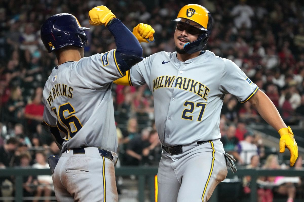 Sep 14, 2024; Phoenix, Arizona, USA; Milwaukee Brewers shortstop Willy Adames (27) celebrates with Blake Perkins (16) after hitting a solo home run against the Arizona Diamondbacks in the fourth inning at Chase Field. Mandatory Credit: Rick Scuteri-Imagn Images