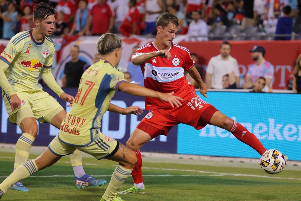 Sep 14, 2024; Chicago, Illinois, USA; Chicago Fire FC forward Tom Barlow (12) controls the ball  against New York Red Bulls defender John Tolkin (47) during the first half of a match at Soldier Field. Mandatory Credit: Melissa Tamez-Imagn Images