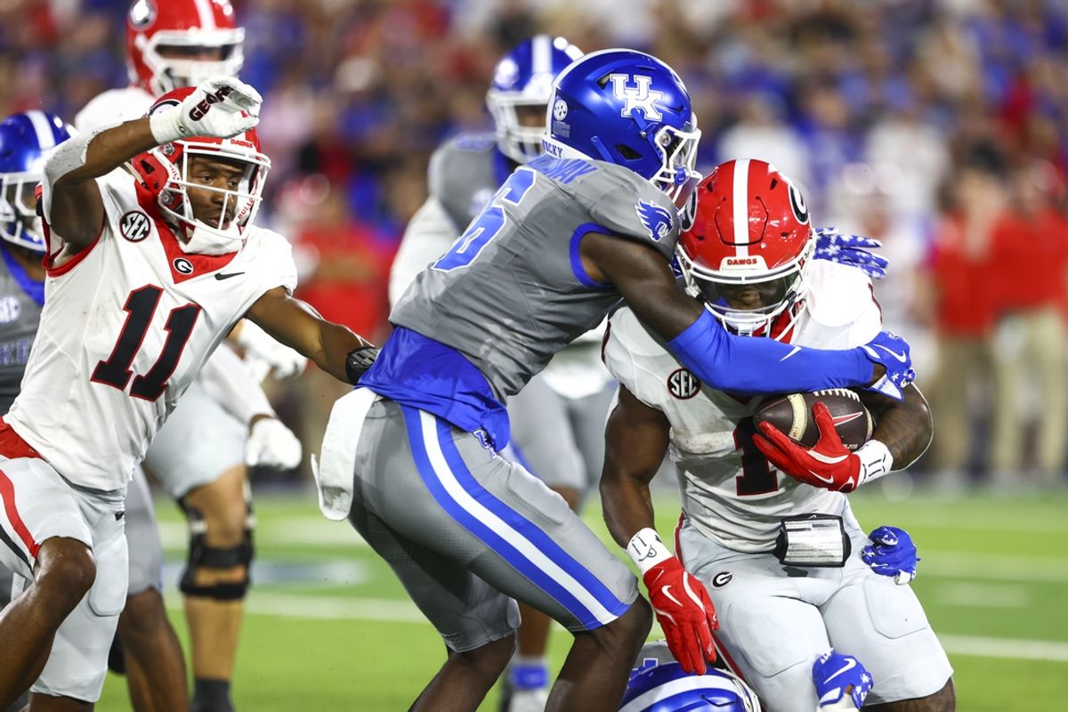 Sep 14, 2024; Lexington, Kentucky, USA; Kentucky Wildcats defensive back JQ Hardaway (6) brings down Georgia Bulldogs running back Trevor Etienne (1) during the second quarter at Kroger Field. Mandatory Credit: Carter Skaggs-Imagn Images