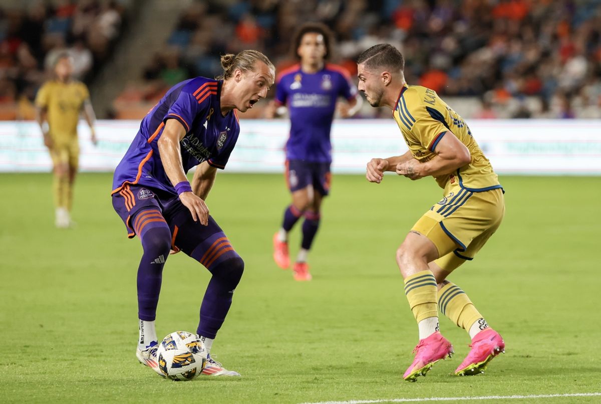 Sep 14, 2024; Houston, Texas, USA;Houston Dynamo FC midfielder Griffin Dorsey (25) challenges Real Salt Lake defender Alexandros Katranis (98) in the first half  at Shell Energy Stadium. Mandatory Credit: Thomas Shea-Imagn Images