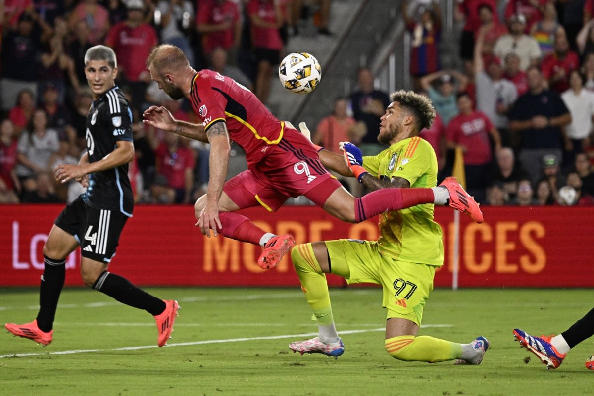 Sep 14, 2024; St. Louis, Missouri, USA; St. Louis CITY SC forward Joao Klauss (9) collides with Minnesota United goalkeeper Dayne St. Clair (97) in the first half at CITYPARK. Mandatory Credit: Joe Puetz-Imagn Images