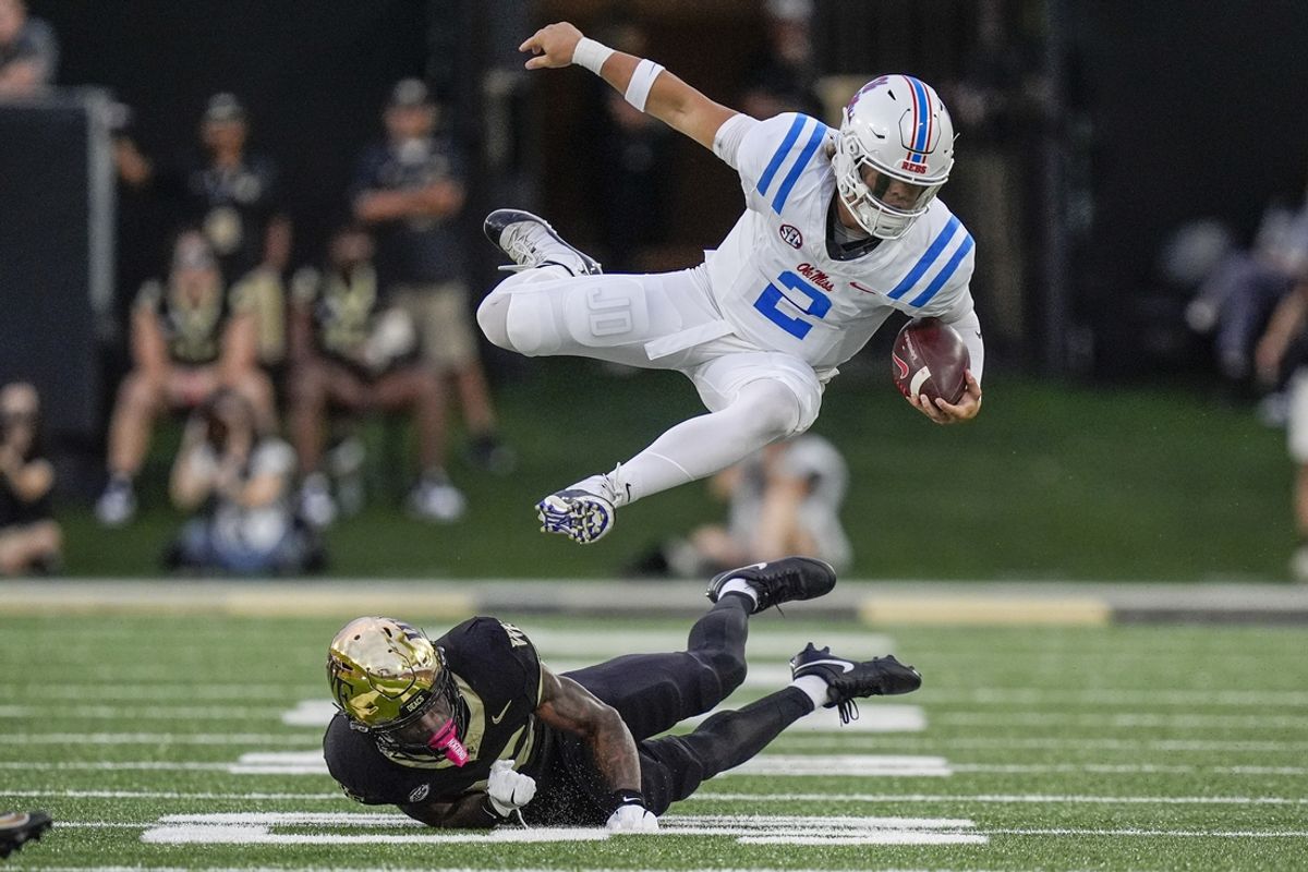 Sep 14, 2024; Winston-Salem, North Carolina, USA;  Wake Forest Demon Deacons linebacker Aiden Hall (39) upends Mississippi Rebels quarterback Jaxson Dart (2) during the first half at Allegacy Federal Credit Union Stadium. Mandatory Credit: Jim Dedmon-Imagn Images