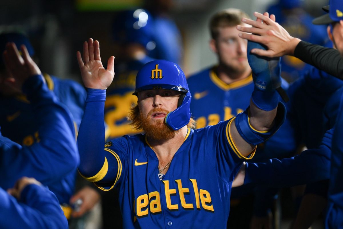 Sep 14, 2024; Seattle, Washington, USA; Seattle Mariners first baseman Justin Turner (2) celebrates after scoring a run against the Texas Rangers during the second inning at T-Mobile Park. Mandatory Credit: Steven Bisig-Imagn Images