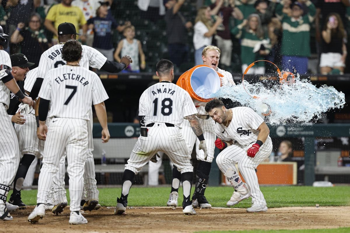 Sep 14, 2024; Chicago, Illinois, USA; Chicago White Sox outfielder Andrew Benintendi (23) celebrates with teammates as he crosses home plate after hitting a walk-off home run against the Oakland Athletics during the ninth inning at Guaranteed Rate Field. Mandatory Credit: Kamil Krzaczynski-Imagn Images