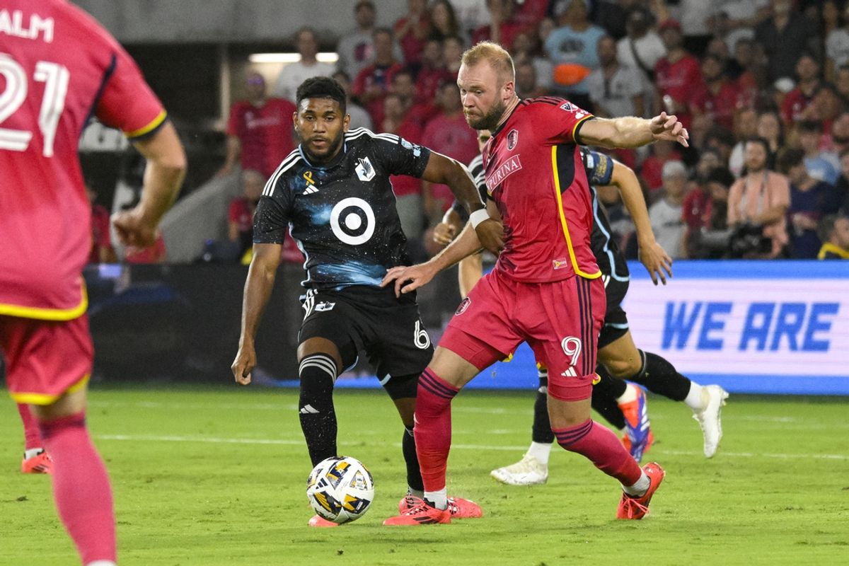 Sep 14, 2024; St. Louis, Missouri, USA; Minnesota United defender Mikael Marques (6) and St. Louis CITY SC forward Joao Klauss (9) battle during the second half at CITYPARK. Mandatory Credit: Scott Rovak-Imagn Images
