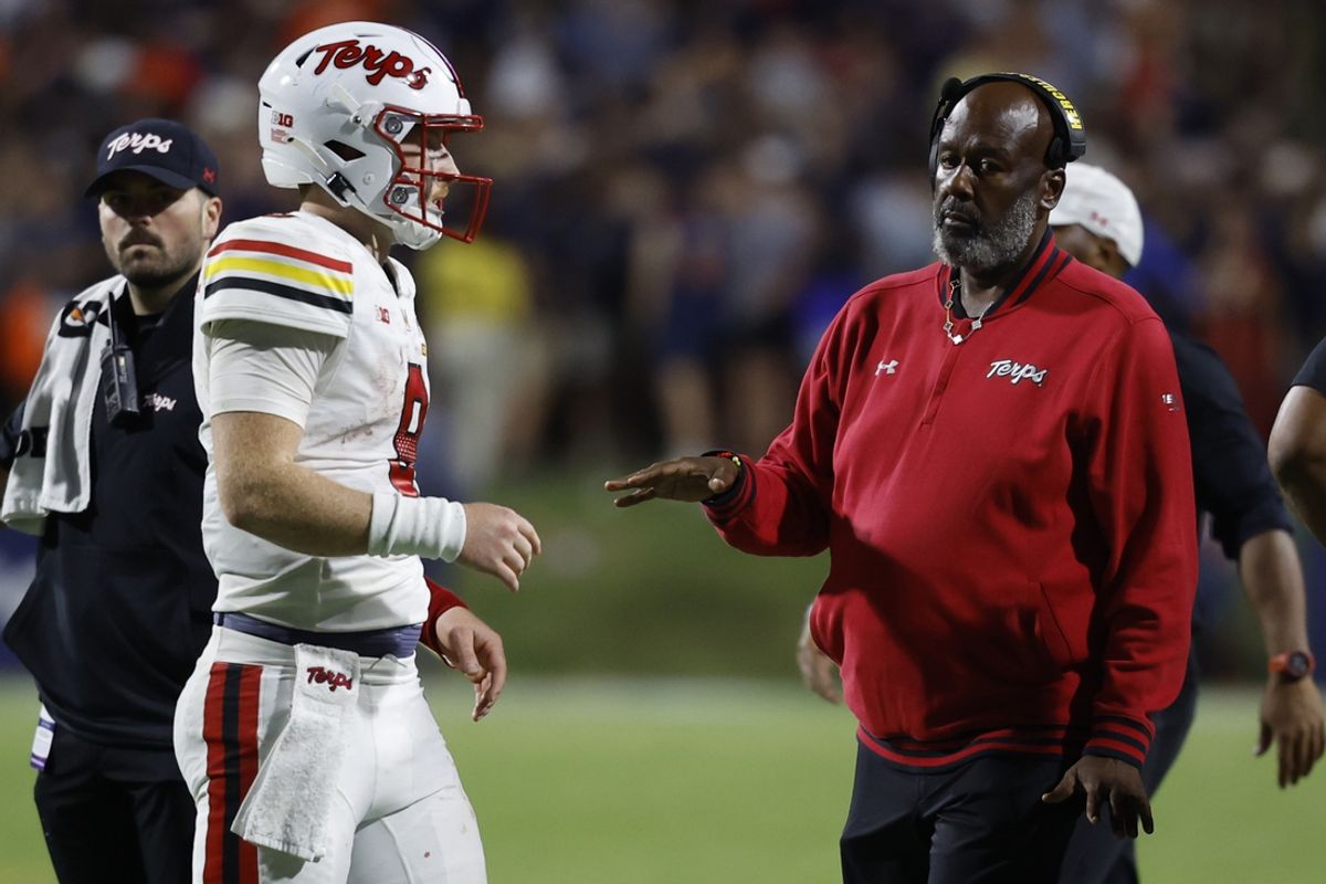 Sep 14, 2024; Charlottesville, Virginia, USA; Maryland Terrapins quarterback Billy Edwards Jr. (9) talks with Terrapins head coach Michael Locksley (R) during a timeout against the Virginia Cavaliers during the second half at Scott Stadium. Mandatory Credit: Geoff Burke-Imagn Images