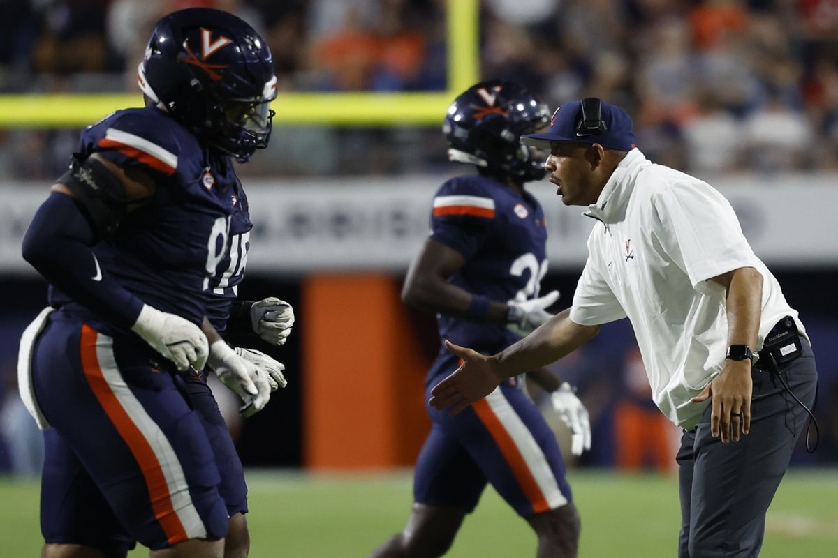Sep 14, 2024; Charlottesville, Virginia, USA; Virginia Cavaliers head coach Tony Elliott encourages his team during a change of possession against the Maryland Terrapins during the first half at Scott Stadium. Mandatory Credit: Geoff Burke-Imagn Images
