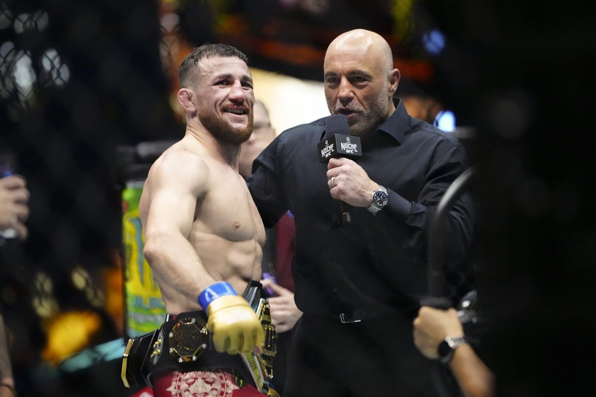 Sep 14, 2024; Las Vegas, Nevada, USA; Merab Dvalishvili of Georgia (blue gloves) talks with Joe Rogan after Dvalishvili defeats Sean O’Malley of the United States (not pictured) during Riyadh Season Noche UFC 306 at The Sphere. Mandatory Credit: Stephen R. Sylvanie-Imagn Images