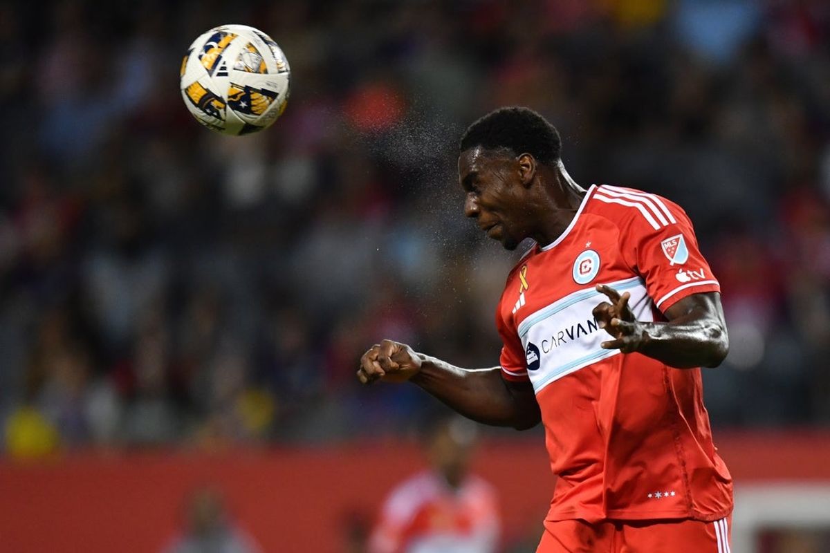 Sep 14, 2024; Chicago, Illinois, USA; Chicago Fire FC defender Carlos Teran (4) heads the ball during the first half against the New York Red Bulls at Soldier Field. Mandatory Credit: Patrick Gorski-Imagn Images