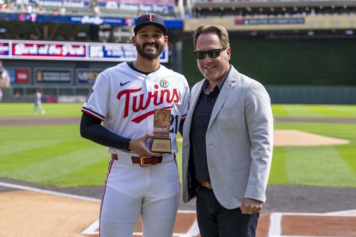 Sep 15, 2024; Minneapolis, Minnesota, USA; Minnesota Twins pitcher Pablo López (49) poses for a photo with Minnesota Twins executive President of Baseball Operations Derek Falvey during pre game before a game against the Cincinnati Reds to receive the Roberto Clemente finalist award at Target Field. Mandatory Credit: Jesse Johnson-Imagn Images