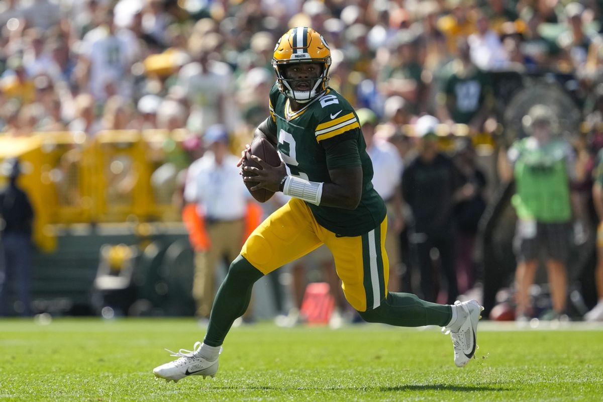 Sep 15, 2024; Green Bay, Wisconsin, USA;  Green Bay Packers quarterback Malik Willis (2) rolls out of the pocket looking to throw a pass during the second quarter against the Indianapolis Colts at Lambeau Field. Mandatory Credit: Jeff Hanisch-Imagn Images