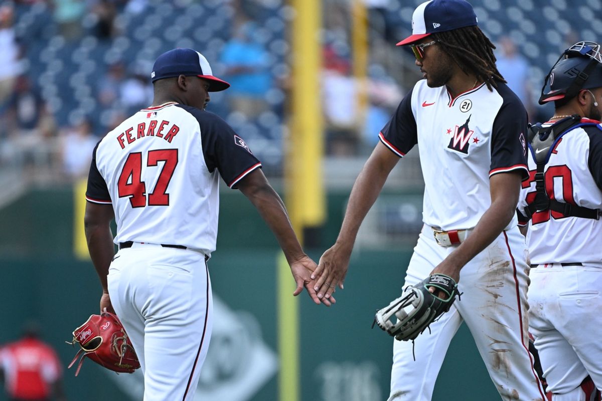 Sep 15, 2024; Washington, District of Columbia, USA; Washington Nationals relief pitcher Jose Ferrer (47) and left fielder James Wood (29) celebrate after defeating the Miami Marlins at Nationals Park. Mandatory Credit: Rafael Suanes-Imagn Images
