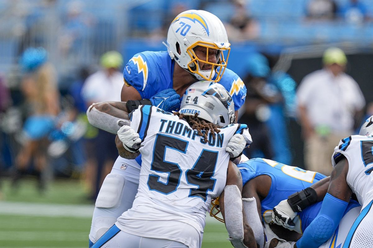 Sep 15, 2024; Charlotte, North Carolina, USA; Los Angeles Chargers offensive tackle Rashawn Slater (70) blocks Carolina Panthers linebacker Shaq Thompson (54) during the second half at Bank of America Stadium. Mandatory Credit: Jim Dedmon-Imagn Images