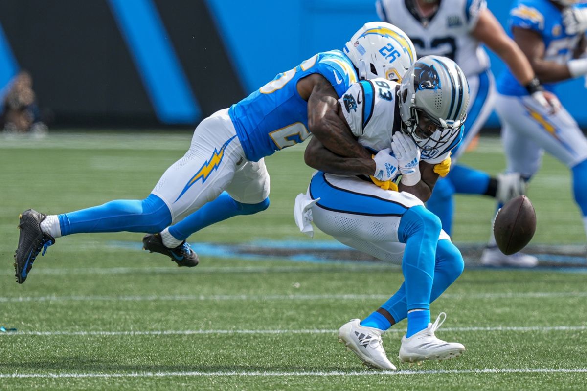 Sep 15, 2024; Charlotte, North Carolina, USA; Los Angeles Chargers cornerback Asante Samuel Jr. (26) tackles Carolina Panthers defensive end LaBryan Ray (93) during the second half at Bank of America Stadium. Mandatory Credit: Jim Dedmon-Imagn Images