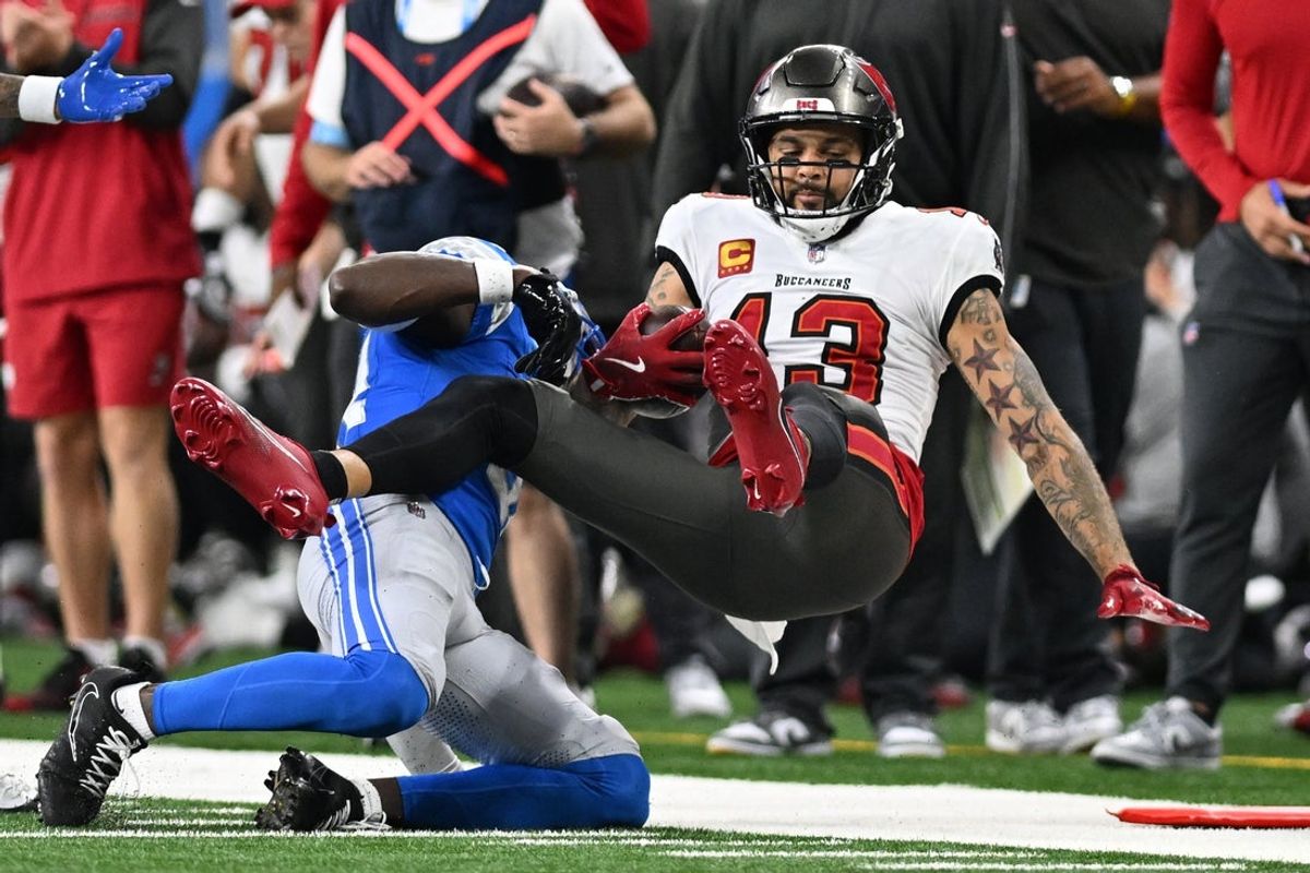 Sep 15, 2024; Detroit, Michigan, USA; Tampa Bay Buccaneers wide receiver Mike Evans (13) gets tackled after making a catch by Detroit Lions safety Kerby Joseph (31) in the fourth quarter at Ford Field. Mandatory Credit: Lon Horwedel-Imagn Images