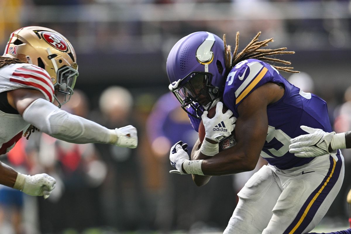 Sep 15, 2024; Minneapolis, Minnesota, USA; Minnesota Vikings running back Aaron Jones (33) runs the ball as San Francisco 49ers linebacker Fred Warner (54) moves in for the tackle during the third quarter U.S. Bank Stadium. Mandatory Credit: Jeffrey Becker-Imagn Images