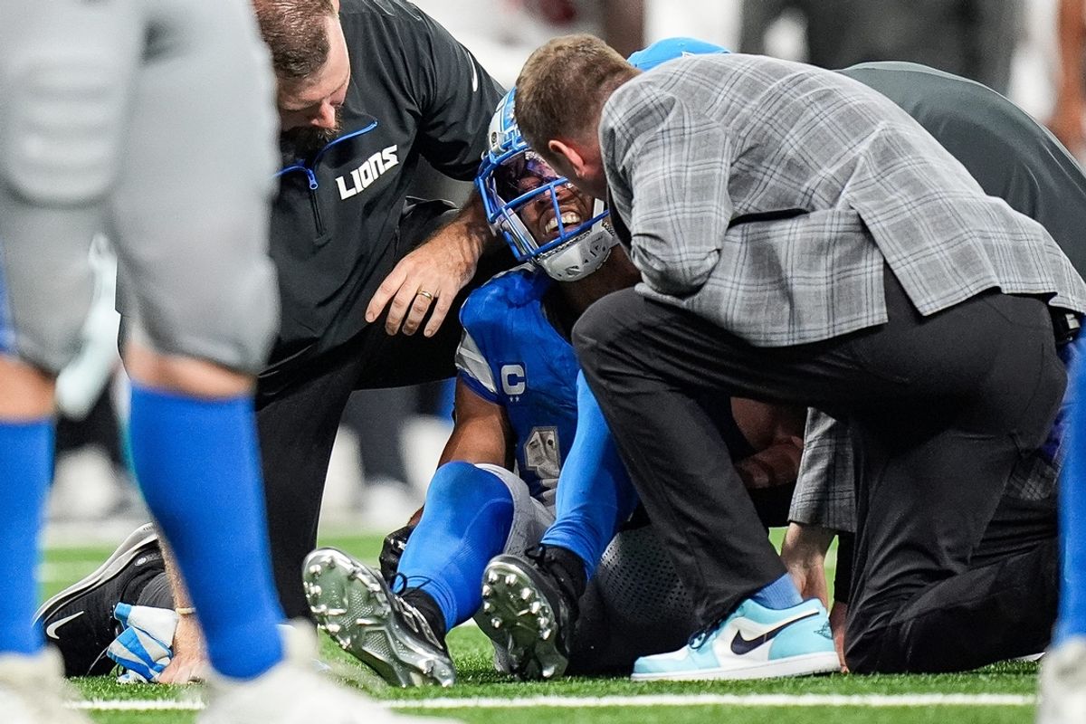 Detroit Lions staff check on wide receiver Amon-Ra St. Brown (14) due to an injury during the second half against Tampa Bay Buccaneers at Ford Field in Detroit on Sunday, September 15, 2024.
