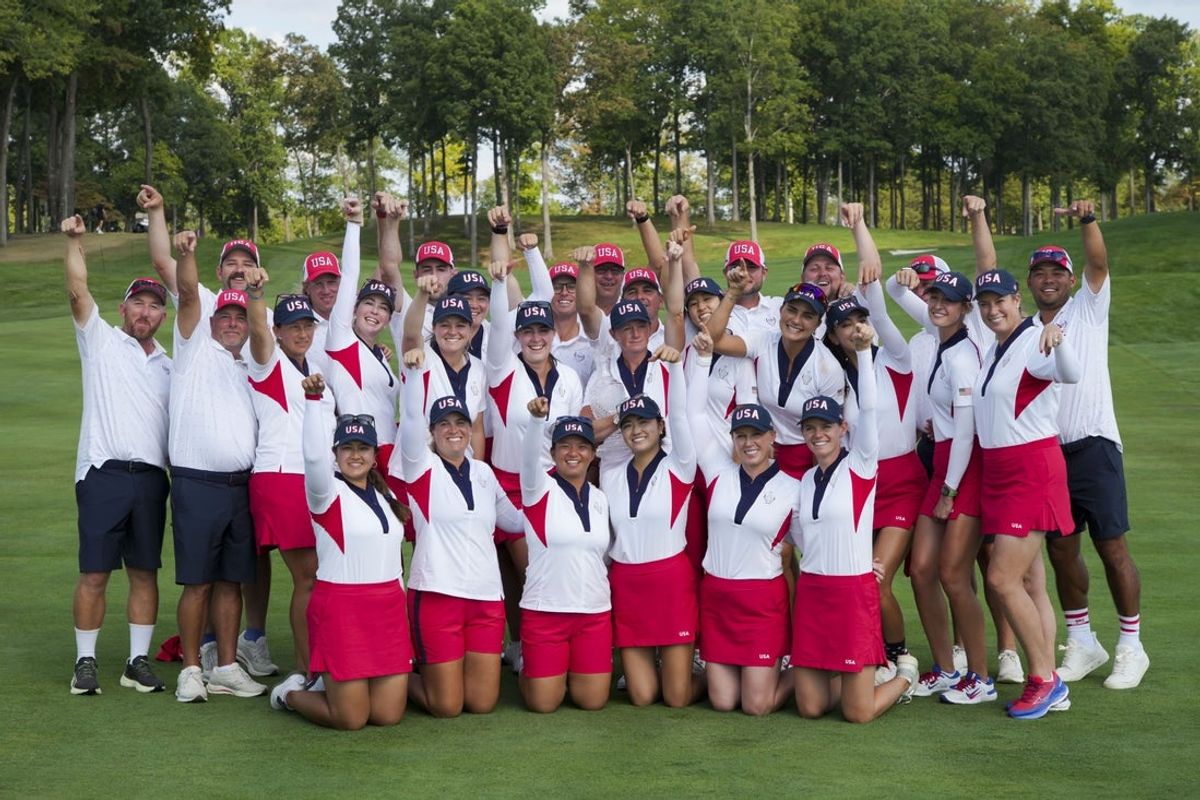 Sep 15, 2024; Gainesville, Virginia, USA; Members of Team USA and their caddies pose for a photo with the trophy after defeating Team Europe at Robert Trent Jones Golf Club. Mandatory Credit: Aaron Doster-Imagn Images