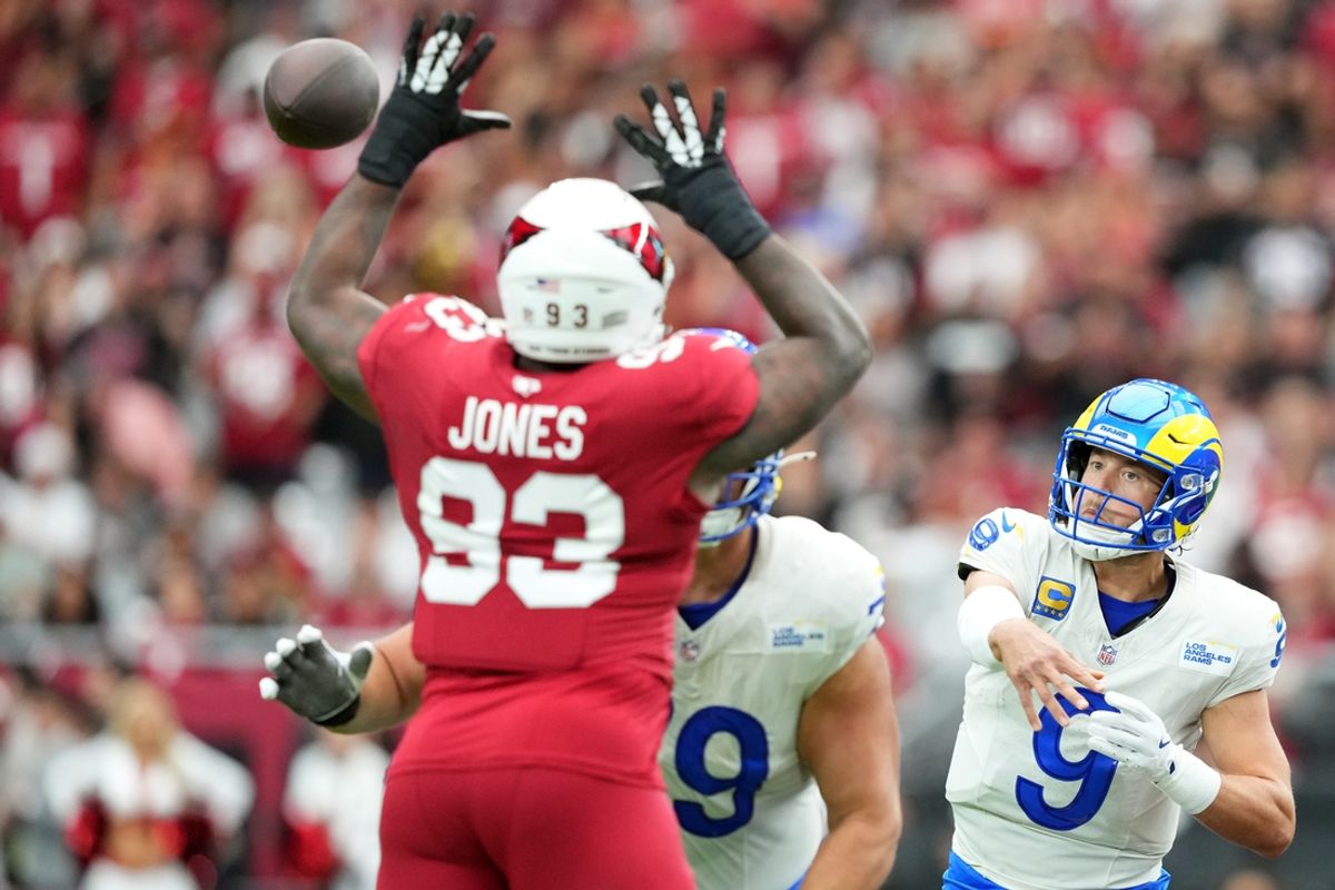 Sep 15, 2024; Glendale, Arizona, USA; Los Angeles Rams quarterback Matthew Stafford (9) throws over Arizona Cardinals defensive tackle Justin Jones (93) during the first half at State Farm Stadium. Mandatory Credit: Joe Camporeale-Imagn Images