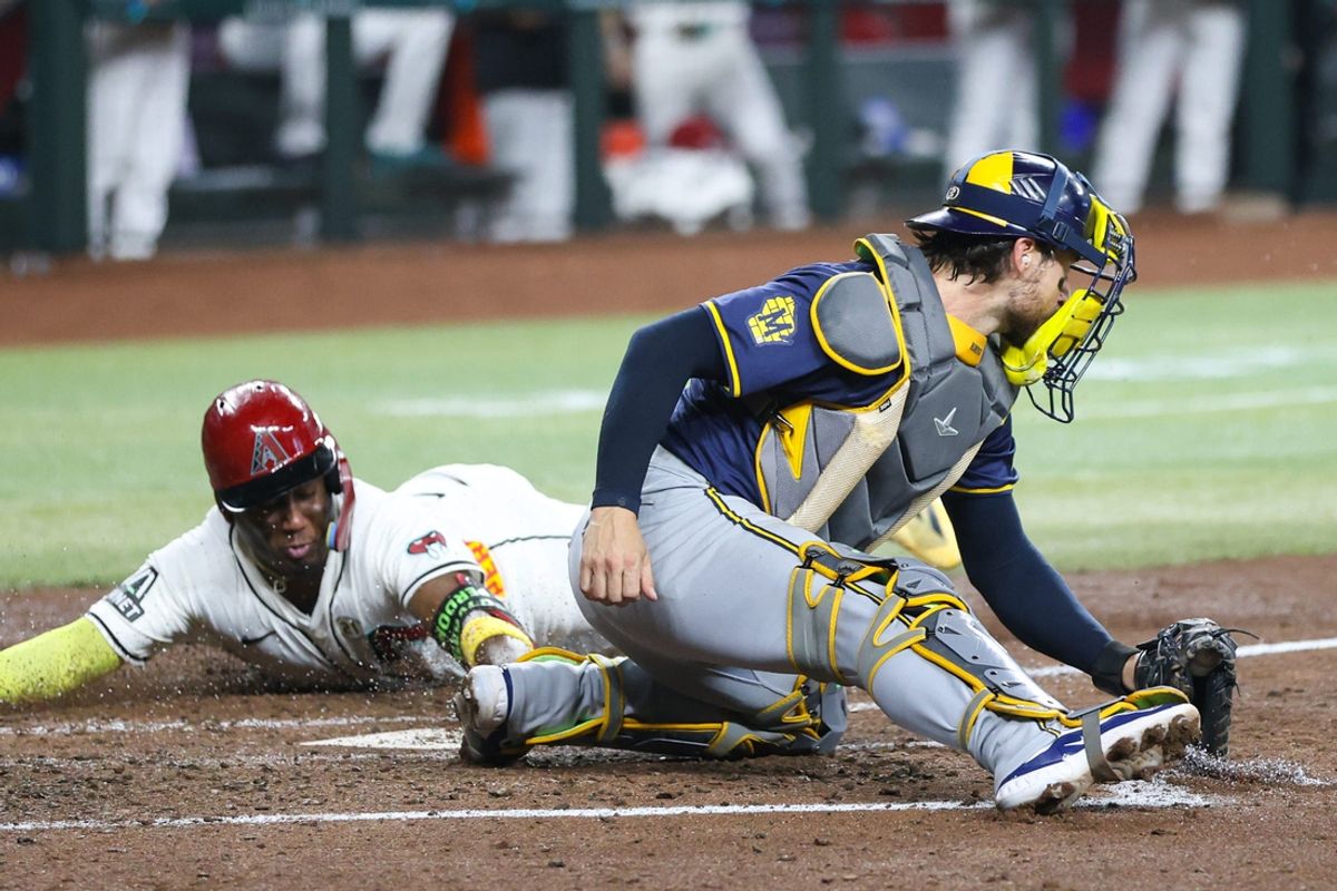 Arizona Diamondbacks infielder Geraldo Perdomo (2) beats the tag and scores on Sept. 15, 2024, at Chase Field in Phoenix.