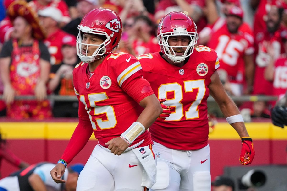 Sep 15, 2024; Kansas City, Missouri, USA; Kansas City Chiefs quarterback Patrick Mahomes (15) and tight end Travis Kelce (87) return to the sidelines after a score against the Cincinnati Bengals during the first half at GEHA Field at Arrowhead Stadium. Mandatory Credit: Denny Medley-Imagn Images