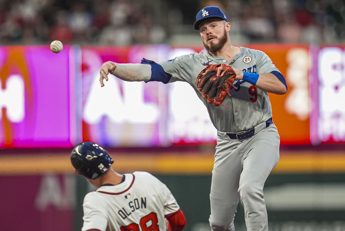 Sep 15, 2024; Cumberland, Georgia, USA; Los Angeles Dodgers second baseman Gavin Lux (9) tries to turn a double play over Atlanta Braves first baseman Matt Olson (28)  during the second inning at Truist Park. Mandatory Credit: Dale Zanine-Imagn Images