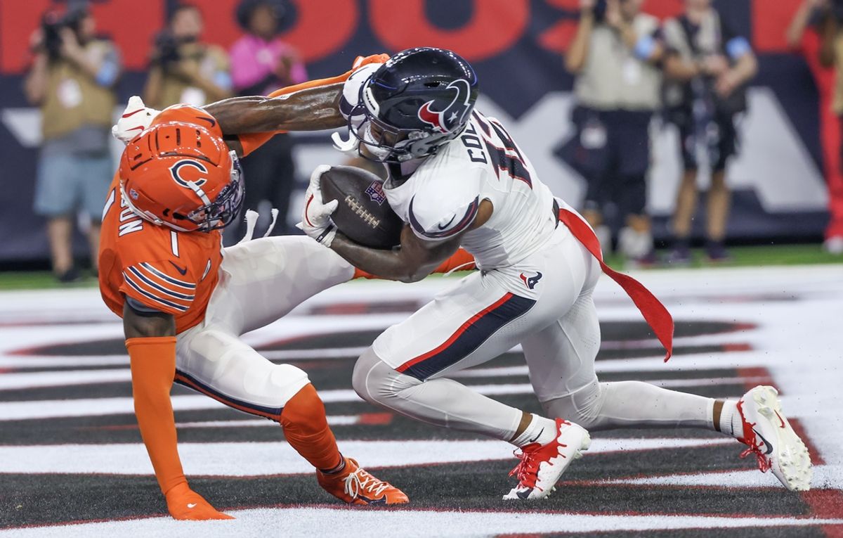 Sep 15, 2024; Houston, Texas, USA;  Houston Texans wide receiver Nico Collins (12) scores a touchdown catch against Chicago Bears cornerback Jaylon Johnson (1) in the second quarter at NRG Stadium. Mandatory Credit: Thomas Shea-Imagn Images