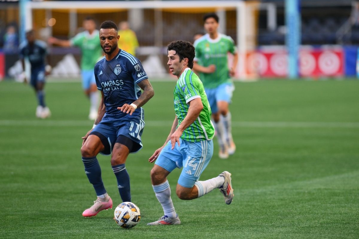 Sep 15, 2024; Seattle, Washington, USA; Seattle Sounders midfielder Paul Rothrock (14) plays the ball defended by Sporting Kansas City forward Khiry Shelton (11) in the second half at Lumen Field. Mandatory Credit: Steven Bisig-Imagn Images