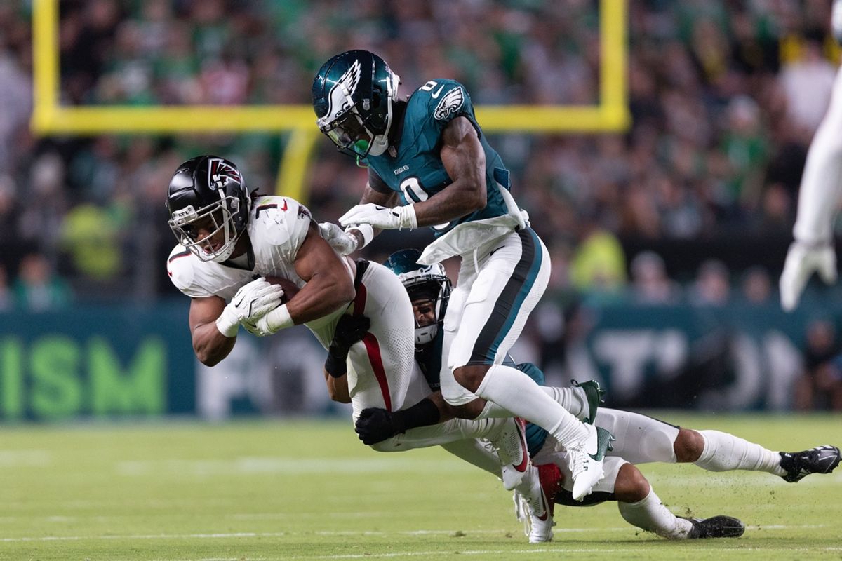 Sep 16, 2024; Philadelphia, Pennsylvania, USA; Philadelphia Eagles defensive end Bryce Huff (0) tackles Atlanta Falcons running back Bijan Robinson (7) after a catch during the second quarter at Lincoln Financial Field. Mandatory Credit: Bill Streicher-Imagn Images