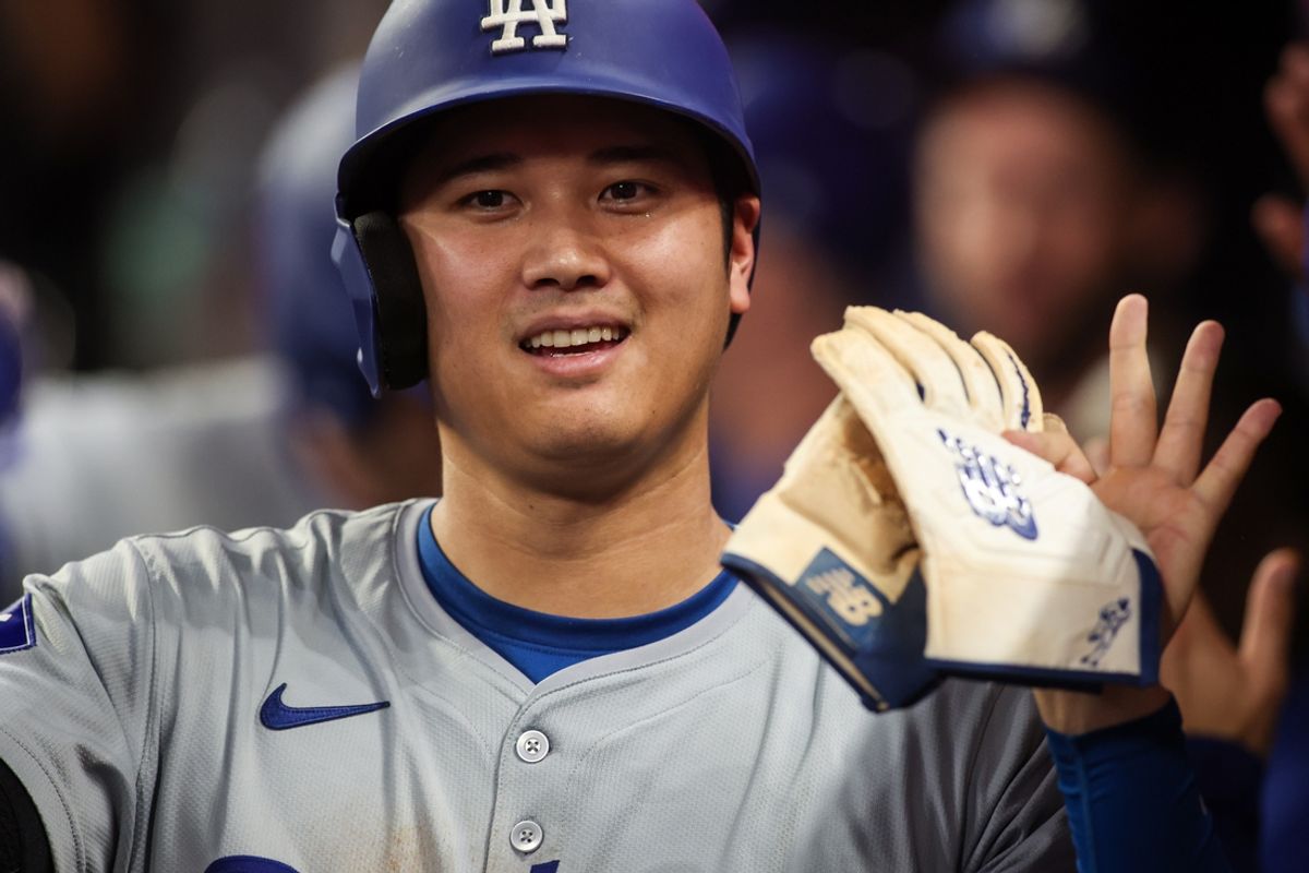 Sep 16, 2024; Atlanta, Georgia, USA; Los Angeles Dodgers designated hitter Shohei Ohtani (17) celebrates with teammates after scoring a run against the Atlanta Braves in the seventh inning at Truist Park. Mandatory Credit: Brett Davis-Imagn Images