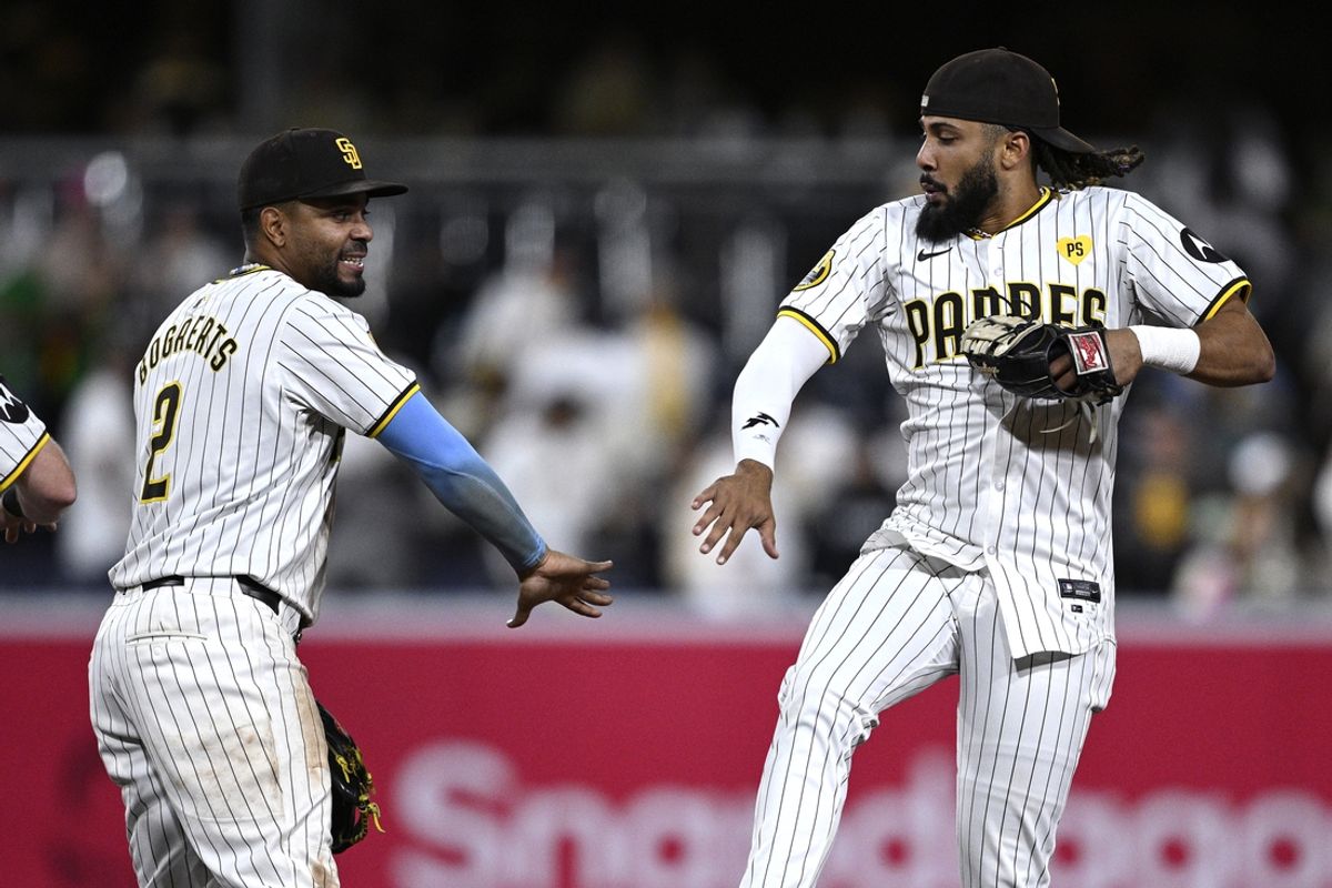 Sep 16, 2024; San Diego, California, USA; San Diego Padres shortstop Xander Bogaerts (2) and right fielder Fernando Tatis Jr. (23) celebrate on the field after defeating the Houston Astros at Petco Park. Mandatory Credit: Orlando Ramirez-Imagn Images