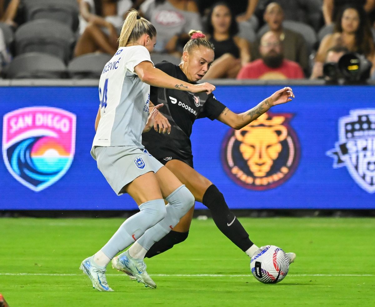 Sep 6, 2024; Los Angeles, California, USA; Seattle Reign defender Ana-Maria Crnogorevic (34) and Angel City FC forward Claire Emslie (10) battle to control the ball during the first half at BMO Stadium. Mandatory Credit: Robert Hanashiro-Imagn Images