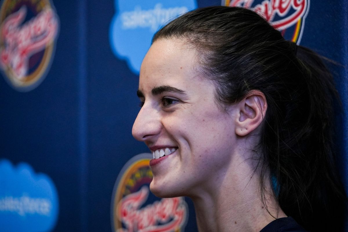 Indiana Fever guard Caitlin Clark (22) smiles while answering a question Tuesday, Sept. 17, 2024, after an Indiana Fever practice at Gainbridge Fieldhouse in Indianapolis.