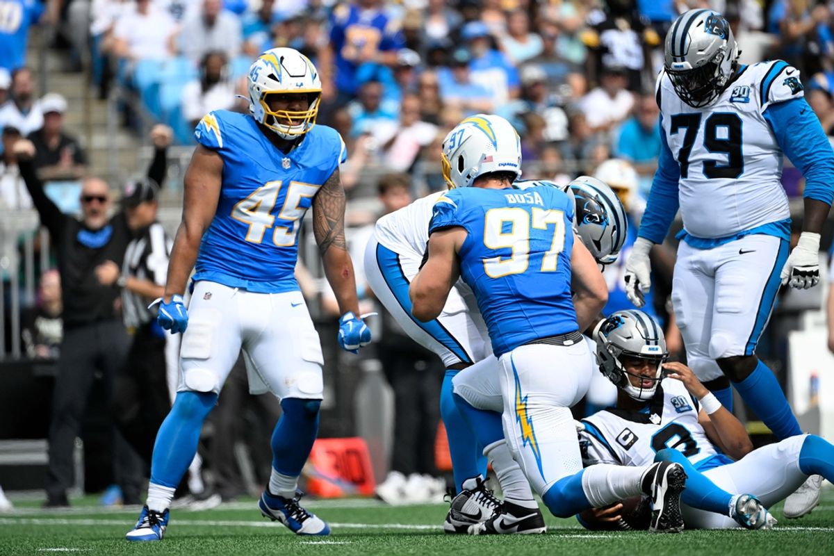 Sep 15, 2024; Charlotte, North Carolina, USA; Los Angeles Chargers linebacker Joey Bosa (97) sacks Carolina Panthers quarterback Bryce Young (9) as linebacker Tuli Tuipulotu (45) looks on in the third quarter at Bank of America Stadium. Mandatory Credit: Bob Donnan-Imagn Images