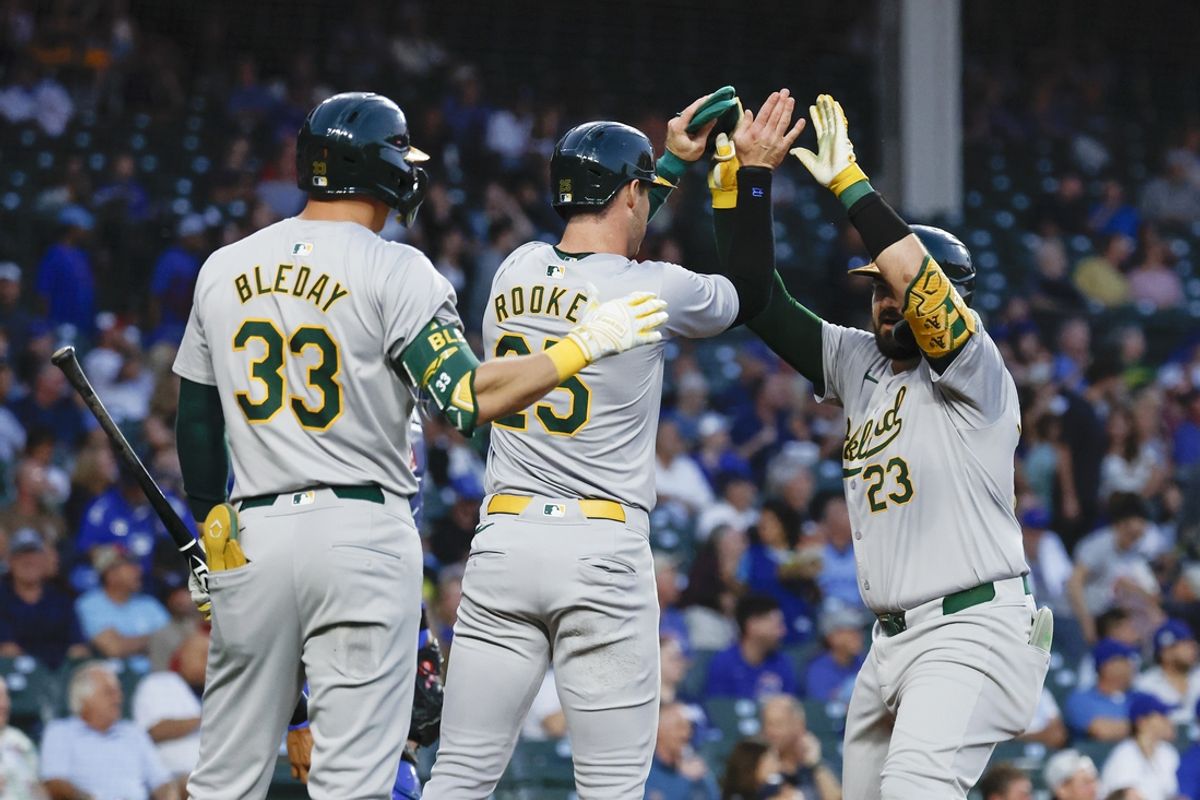 Sep 17, 2024; Chicago, Illinois, USA; Oakland Athletics catcher Shea Langeliers (23) celebrates with teammates after hitting a two-run home run against the Chicago Cubs during the first inning at Wrigley Field. Mandatory Credit: Kamil Krzaczynski-Imagn Images