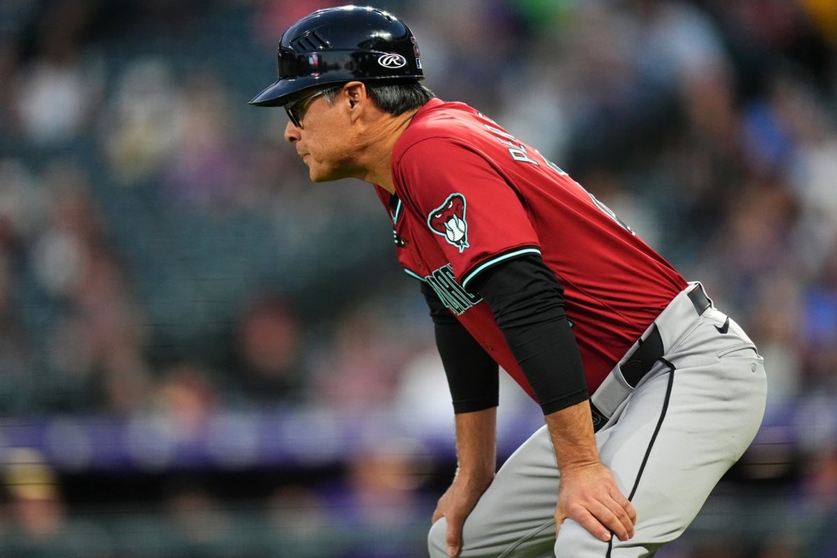 Sep 17, 2024; Denver, Colorado, USA; Arizona Diamondbacks third base coach Tony Perezchica (21) during the second inning against the Colorado Rockies at Coors Field. Mandatory Credit: Ron Chenoy-Imagn Images