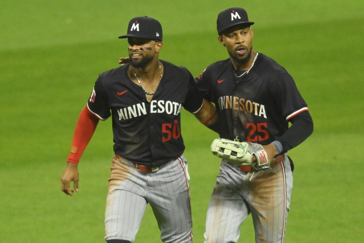 Sep 17, 2024; Cleveland, Ohio, USA; Minnesota Twins left fielder Willi Castro (50) and center fielder Byron Buxton (25) celebrate a win over the Cleveland Guardians at Progressive Field. Mandatory Credit: David Richard-Imagn Images
