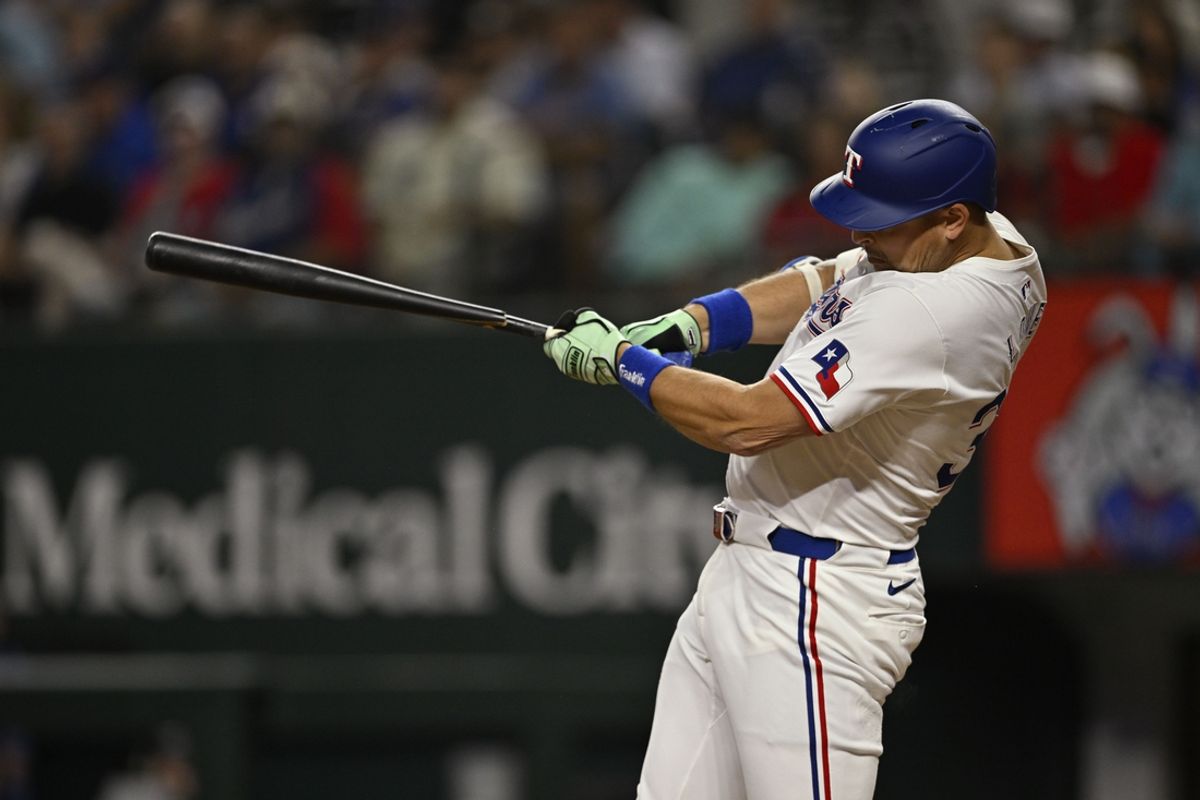 Sep 17, 2024; Arlington, Texas, USA; Texas Rangers first baseman Nathaniel Lowe (30) breaks his bat as he hits a single and drives in a run against the Toronto Blue Jays during the fourth inning at Globe Life Field. Mandatory Credit: Jerome Miron-Imagn Images