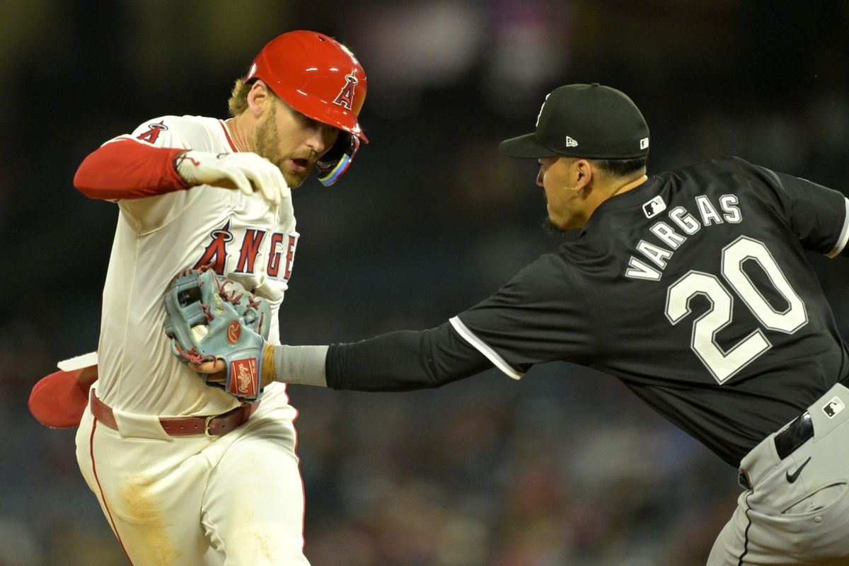 Sep 17, 2024; Anaheim, California, USA;  Los Angeles Angels left fielder Taylor Ward (3) is tagged out by Chicago White Sox third baseman Miguel Vargas (20) in the third inning at Angel Stadium. Mandatory Credit: Jayne Kamin-Oncea-Imagn Images