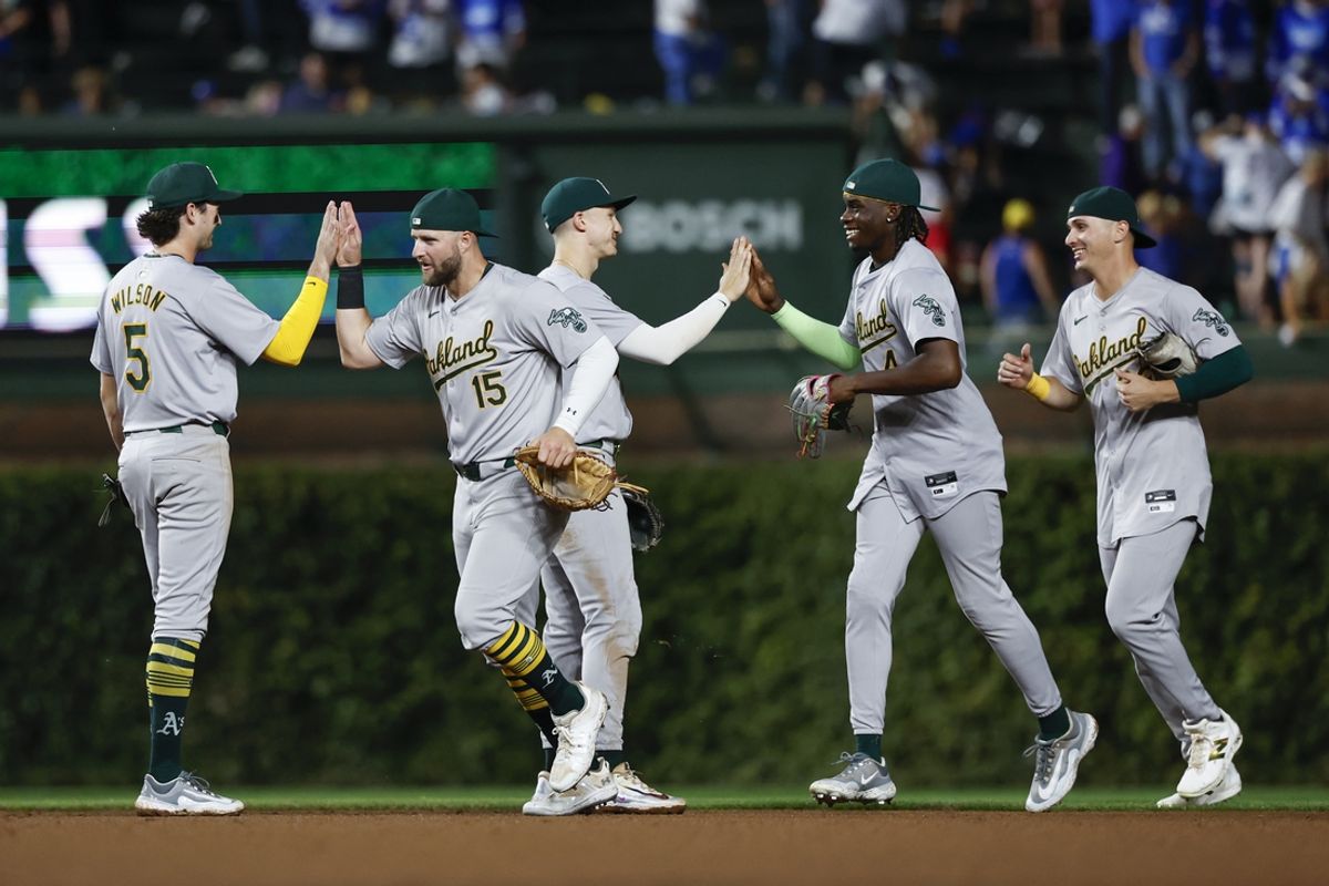 Sep 17, 2024; Chicago, Illinois, USA; Oakland Athletics players celebrate after defeating the Chicago Cubs in a baseball game at Wrigley Field. Mandatory Credit: Kamil Krzaczynski-Imagn Images