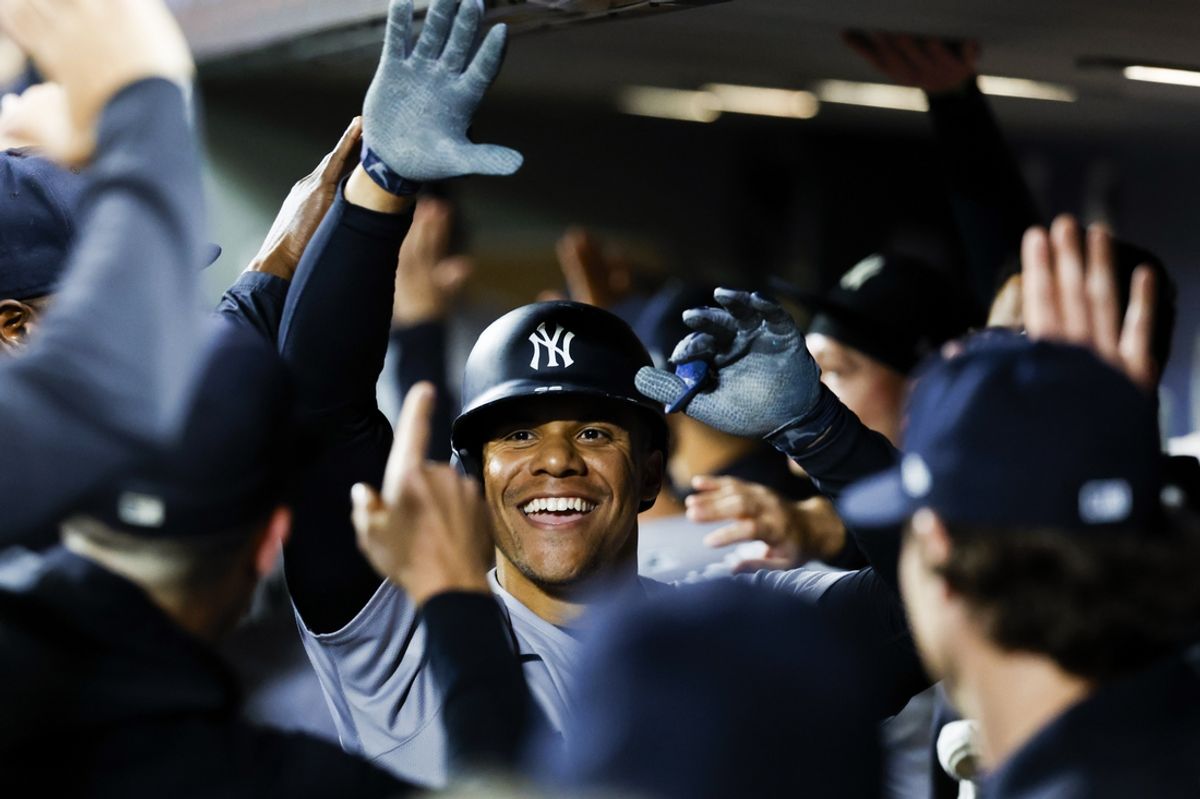 Sep 17, 2024; Seattle, Washington, USA; New York Yankees right fielder Juan Soto (22) celebrates with teammates in the dugout after hitting a two-run home run against the Seattle Mariners during the fourth inning at T-Mobile Park. Mandatory Credit: Joe Nicholson-Imagn Images