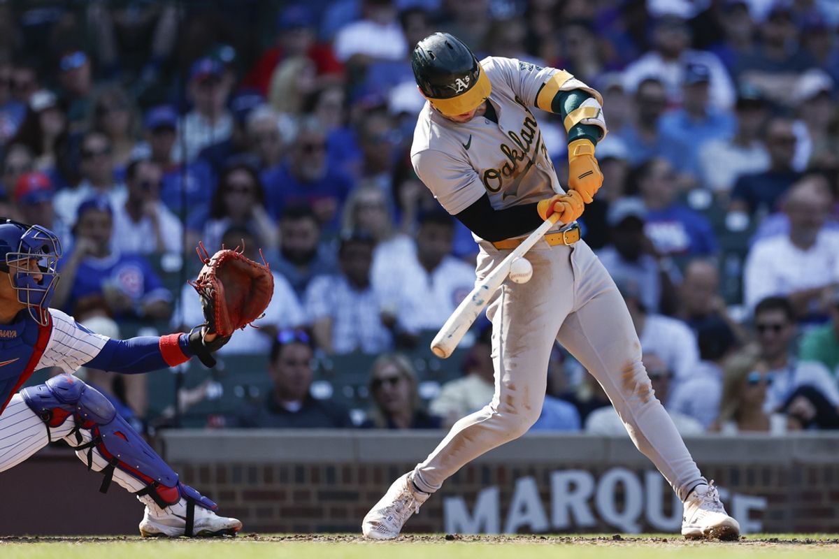 Sep 18, 2024; Chicago, Illinois, USA; Oakland Athletics outfielder Brent Rooker (25) hits an RBI-single against the Chicago Cubs during the seventh inning at Wrigley Field. Mandatory Credit: Kamil Krzaczynski-Imagn Images