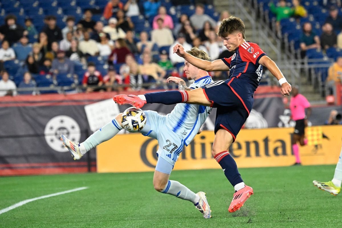 Sep 18, 2024; Foxborough, Massachusetts, USA; New England Revolution forward Esmir Bajraktarevic (47) shoots against CF Montreal defender Dawid Bugal (27) during the first half at Gillette Stadium. Mandatory Credit: Eric Canha-Imagn Images