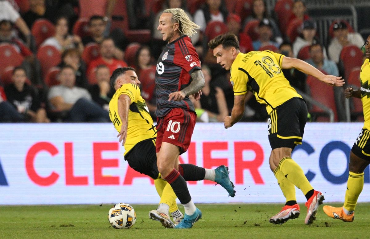 Sep 18, 2024; Toronto, Ontario, CAN;  Toronto FC defender Federico Bernardeschi (10) moves the ball past Columbus Crew defender Malte Amundsen (18) and midfielder Sean Zawadzki (25) in the first half at BMO Field. Mandatory Credit: Dan Hamilton-Imagn Images