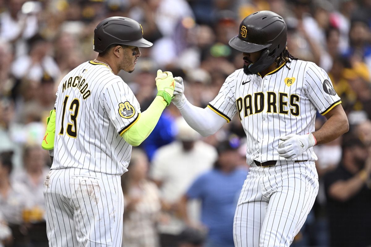 Sep 18, 2024; San Diego, California, USA; San Diego Padres designated hitter Fernando Tatis Jr. (right) celebrates with third baseman Manny Machado (13) after hitting a home run against the Houston Astros during the eighth inning at Petco Park. Mandatory Credit: Orlando Ramirez-Imagn Images